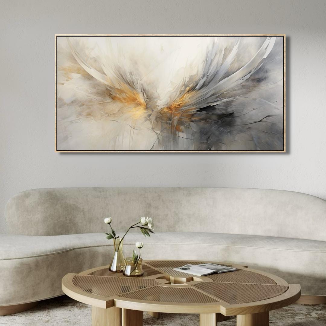 Abstract painting on a wall above a beige sofa with a wooden coffee table.