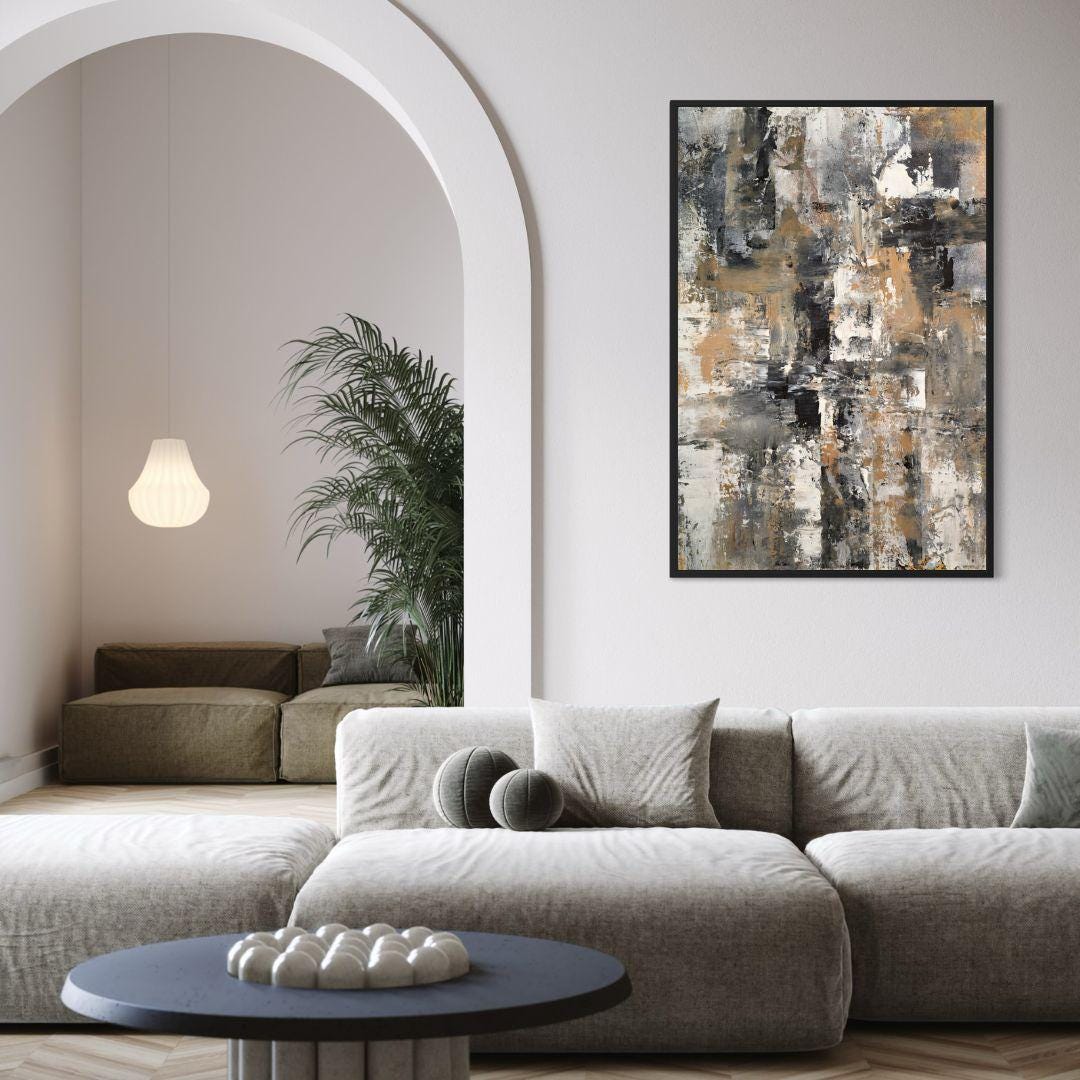 Modern living room with a gray sectional sofa, abstract art on the wall, and a small table with decorative items.