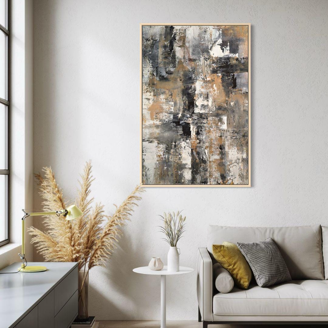 Modern living room with abstract art, sofa, and decorative items.
